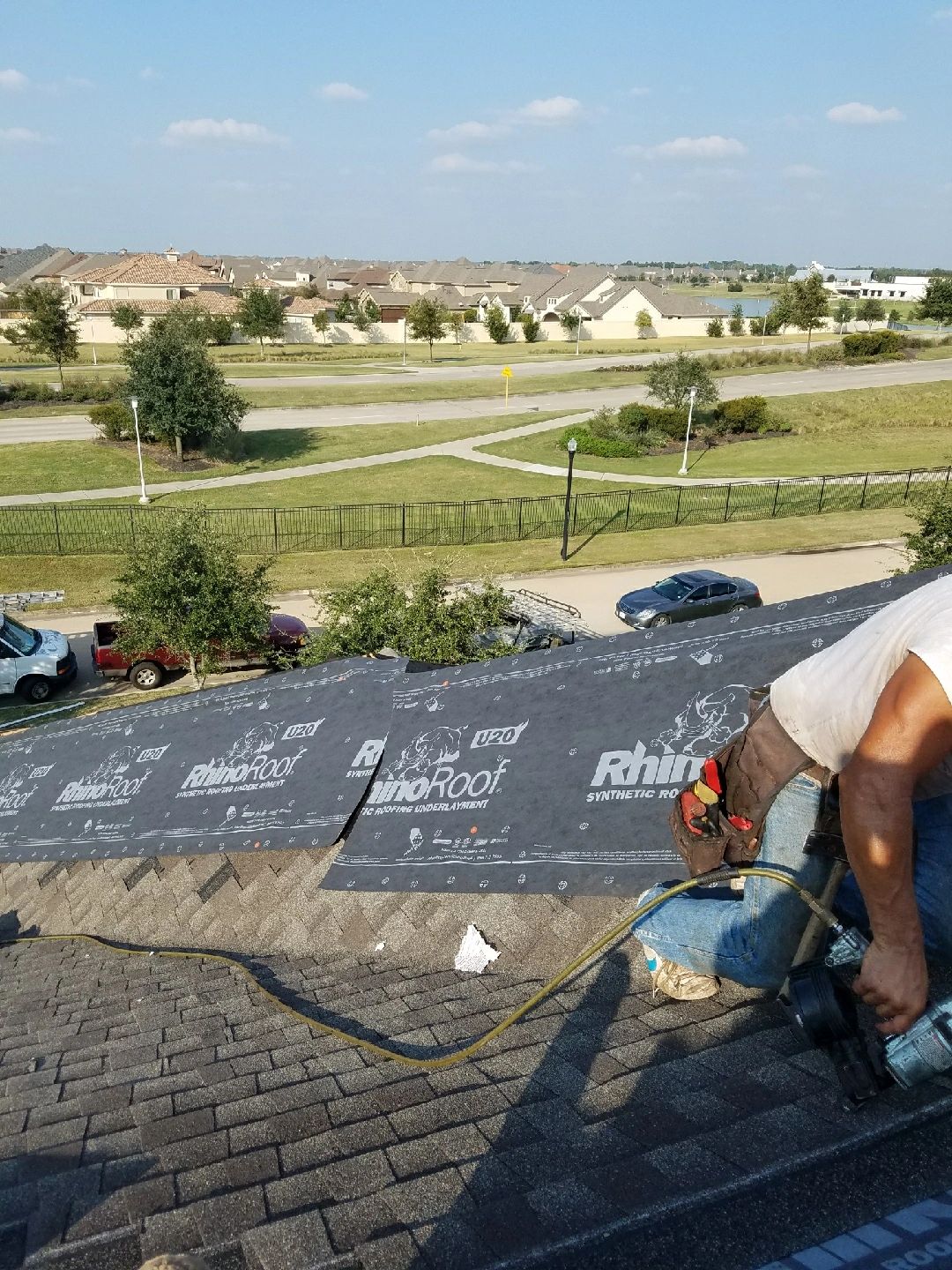 Rooftop construction worker in suburban neighborhood